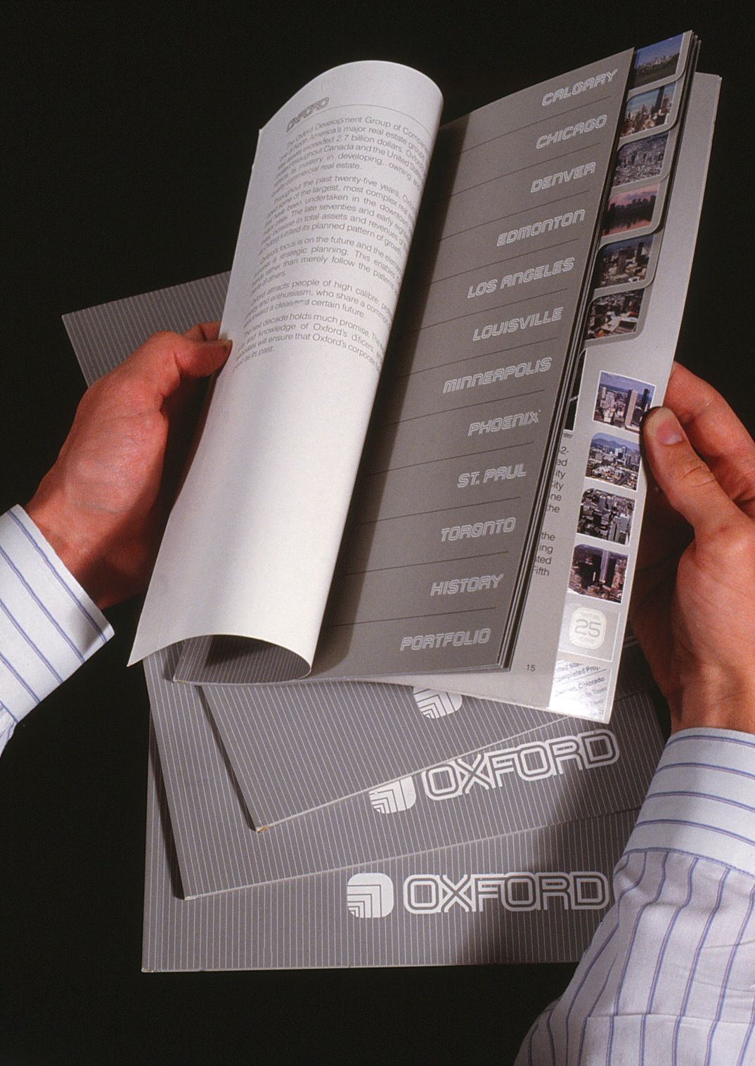 Projects brochure opened by hands and showing the prject names on page three and tabs at right for quick reference to each.