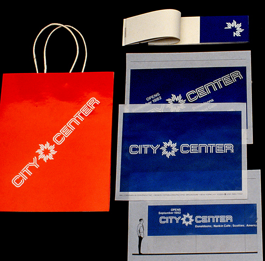 An assortment of folders, booklet and a large bags featuring the City Center logo and signature.