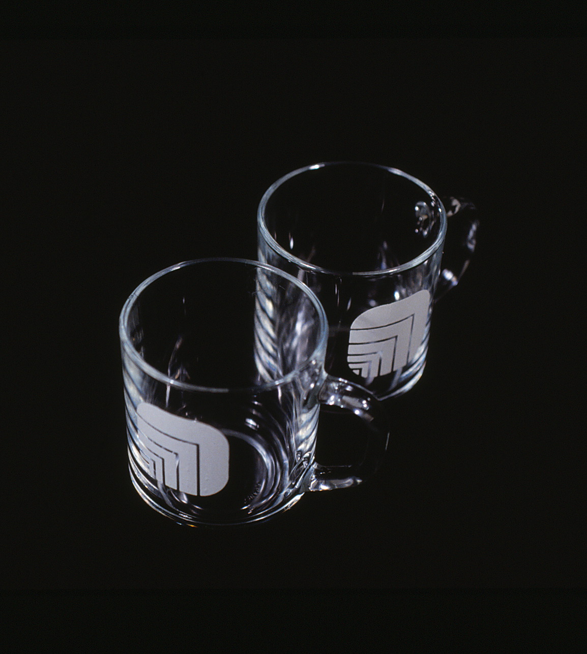 Pair of glass coffee mugs with Oxford logos.