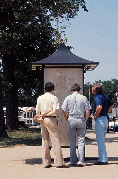Men looking at kiosk