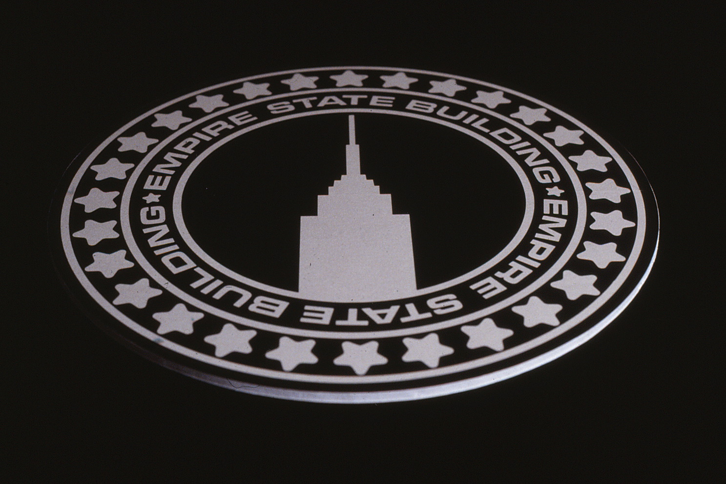 Design of a manhole cover with the Empire State design on it.