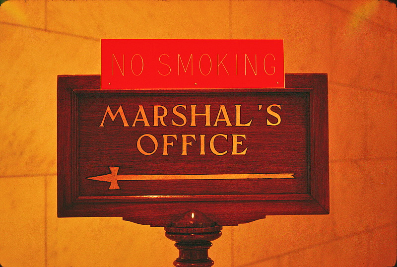 Old sign inside Capitol Building directing towards the Marshall's Office.