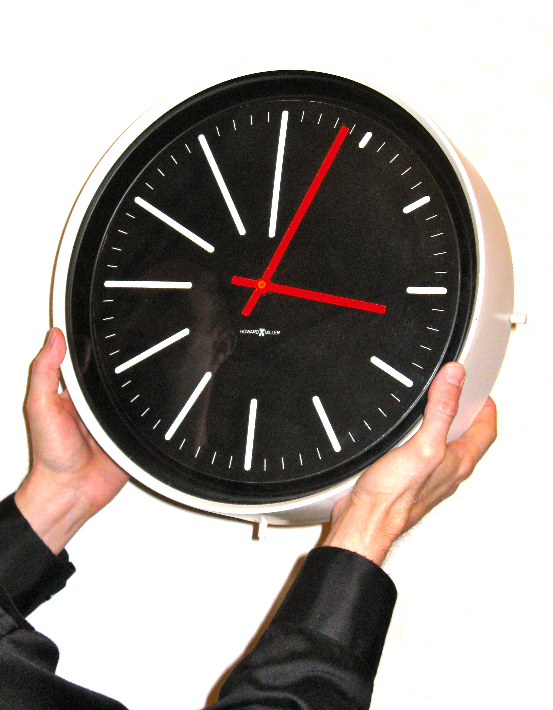 Picture showing a man holding a clock to show scale