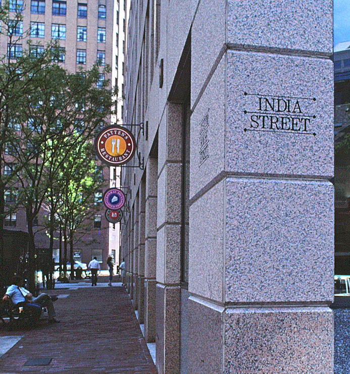 Closeup of the 21 Custom House Street address chisled into the corner stone pillar facing the street.