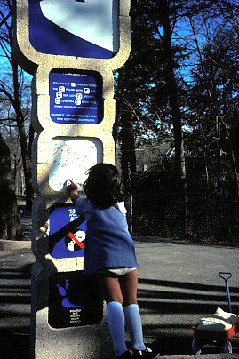 Female child looking at a totem display