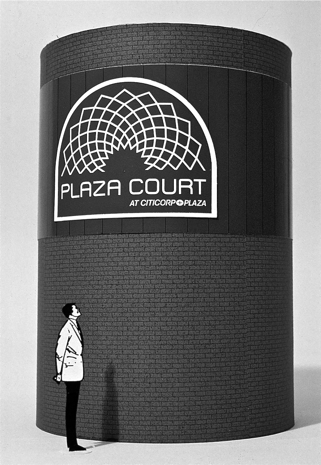 SCale model featuring a man looking up at a large circular brick outdoor ventilation vent with the Plaza Court logo on it.