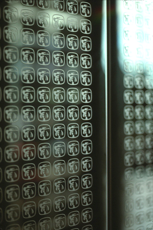 Elevator doors showing the etched repeat pattern of the Quaker Symbol.