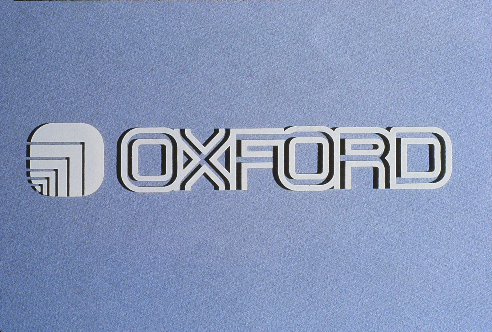 The raised Oxford logo and typeface as it looks on a wall.
