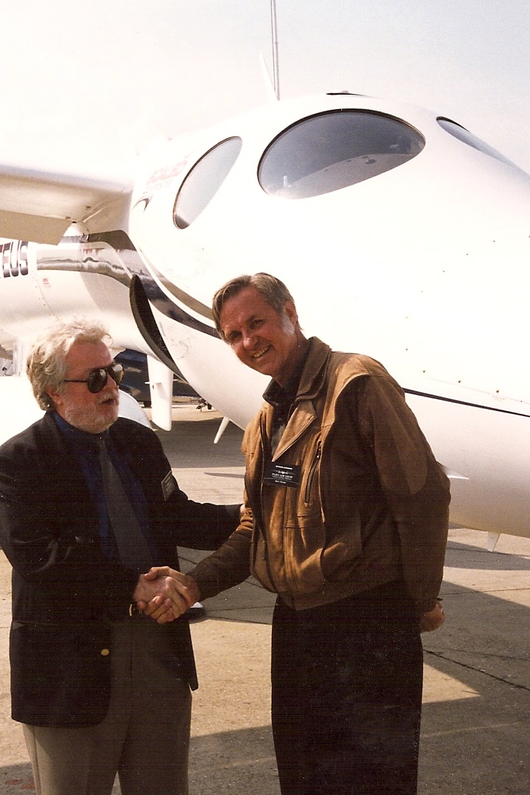 Burt Rutan shaking hands with a journalist.