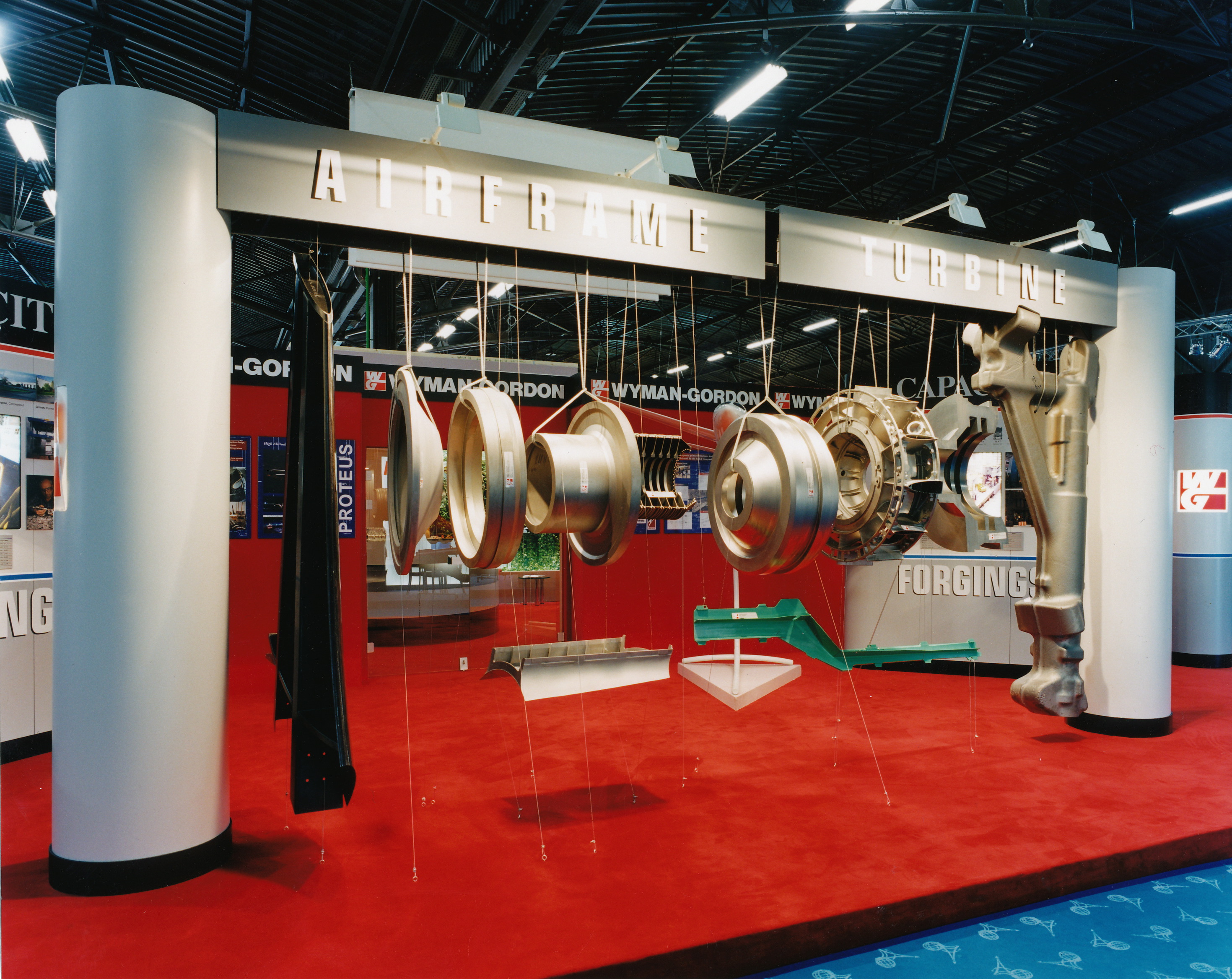 Hanging display of jet engine component parts hanging in an exploded view.